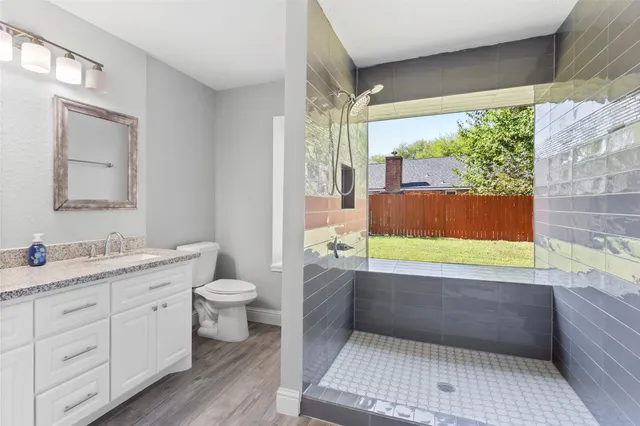 a bathroom with a granite countertop sink a toilet and a bathtub