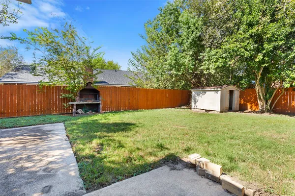a backyard of a house with a garden and plants