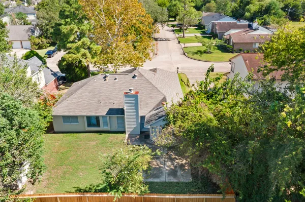 an aerial view of a house with yard swimming pool and outdoor seating