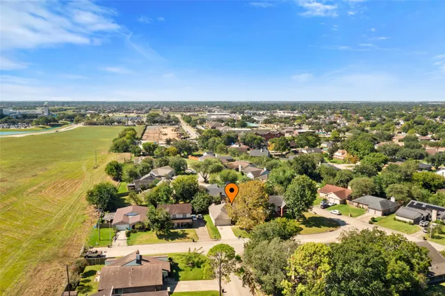 an aerial view of residential houses with outdoor space