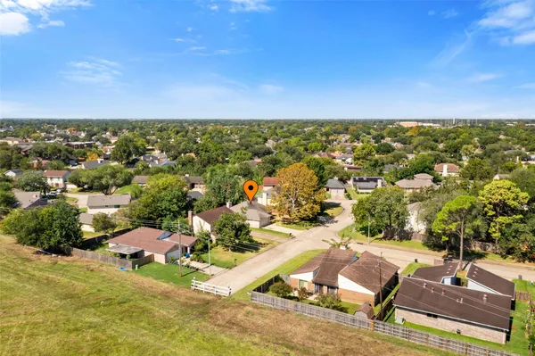 an aerial view of residential houses with outdoor space