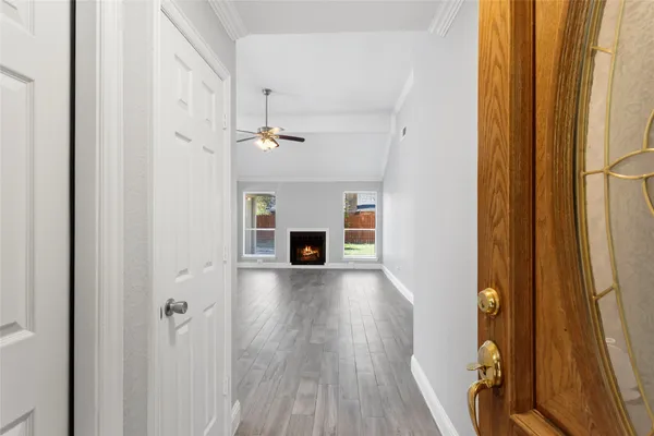 a view of a hallway with wooden floor and staircase