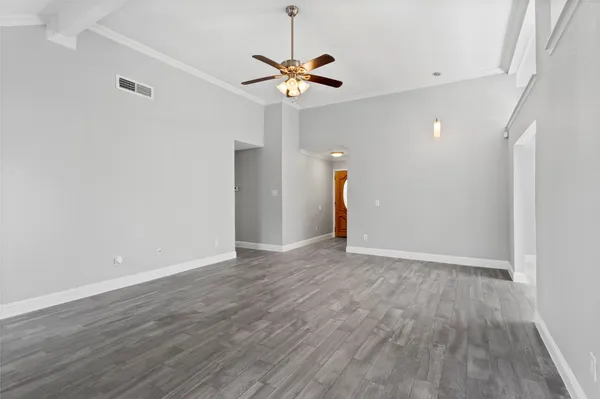 a view of a livingroom with a ceiling fan and wooden floor