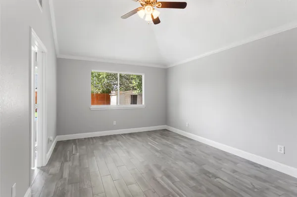 wooden floor in an empty room with a window