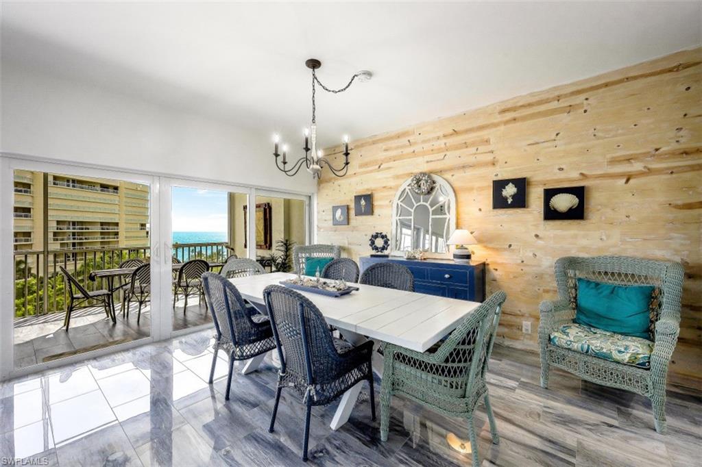 1 Bluebill Avenue, Unit 803 Naples, FL 34108 - Photo 11 of 19 a view of a dining room with furniture window and wooden floor