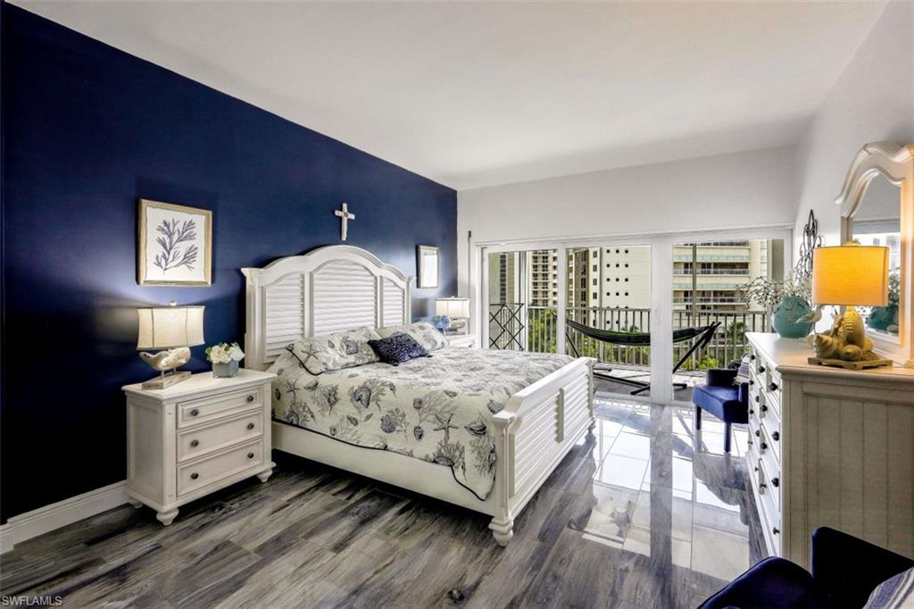 1 Bluebill Avenue, Unit 803 Naples, FL 34108 - Photo 12 of 19 a bedroom with a bed and wooden floor