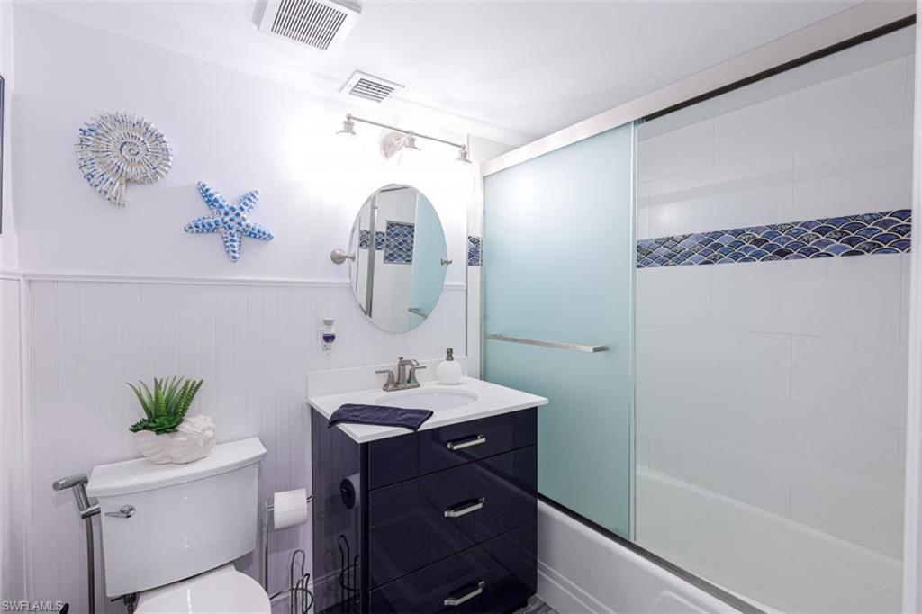 1 Bluebill Avenue, Unit 803 Naples, FL 34108 - Photo 15 of 19 a bathroom with a sink and a mirror