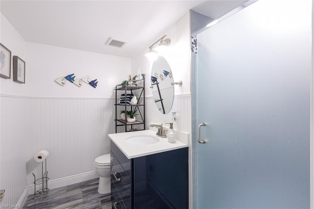 1 Bluebill Avenue, Unit 803 Naples, FL 34108 - Photo 17 of 19 a bathroom with a sink vanity and a mirror