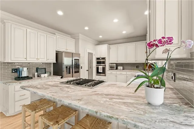 a kitchen with a potted plant on the counter and cabinets
