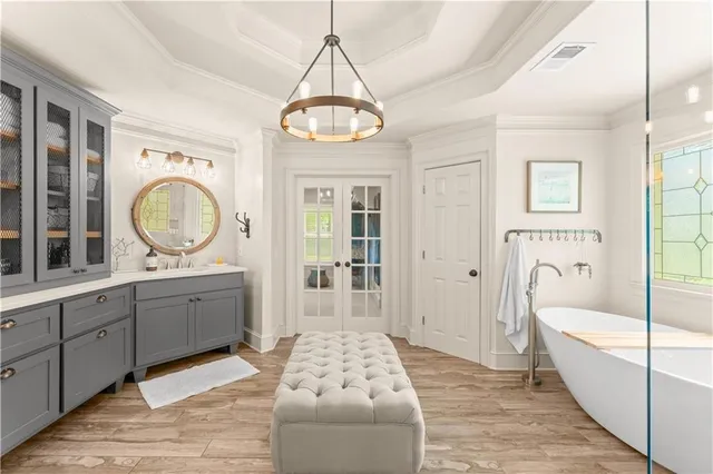 a large spacious bathroom with a double vanity sink a mirror and a bathtub