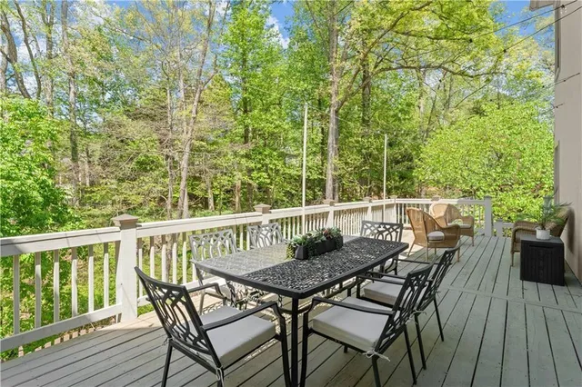 a view of balcony with furniture and trees