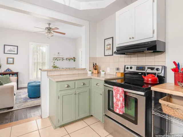 a kitchen with stainless steel appliances granite countertop a stove sink and cabinets