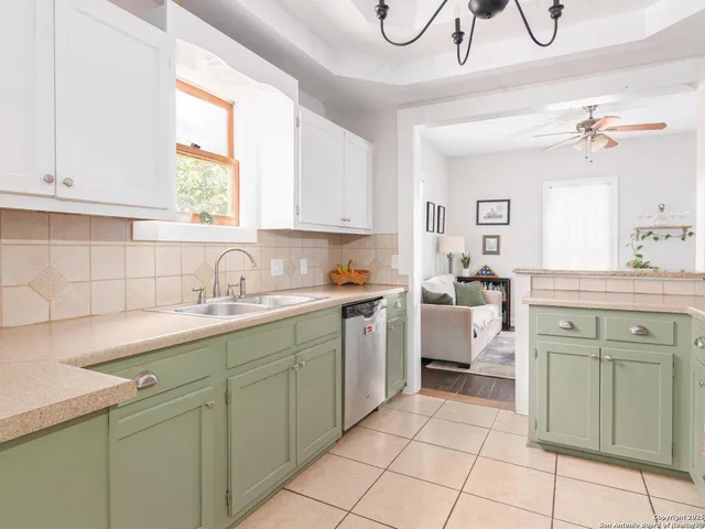 a kitchen with cabinets appliances and a window