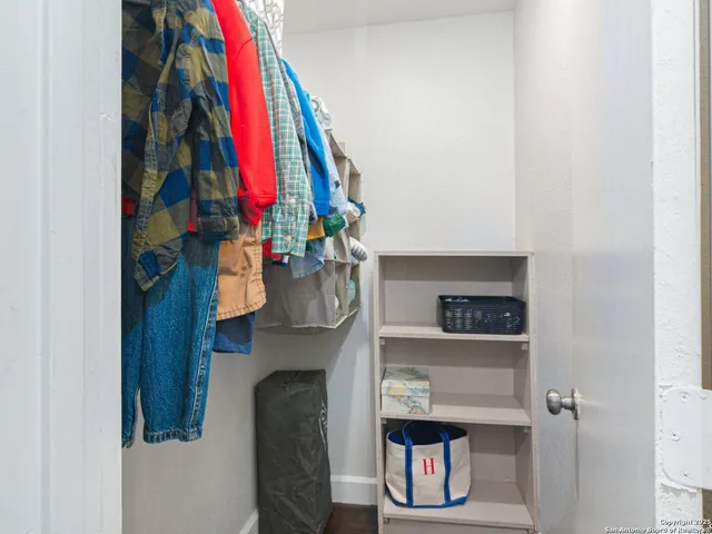 a view of walk in closet with clothes and shoes