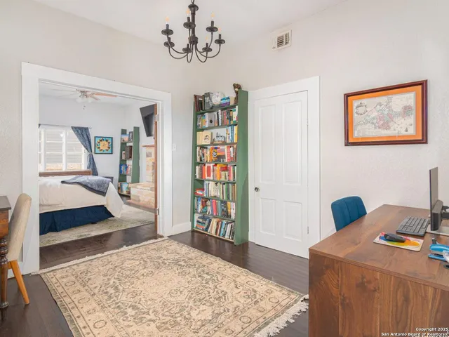 a bedroom with a bed and a dresser in it