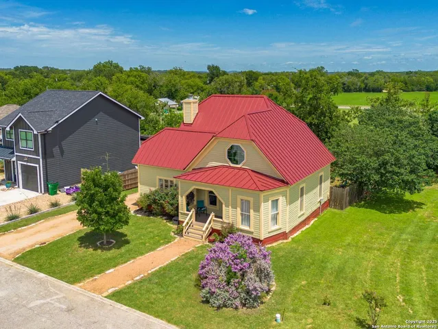 a view of a yard with a house in the background