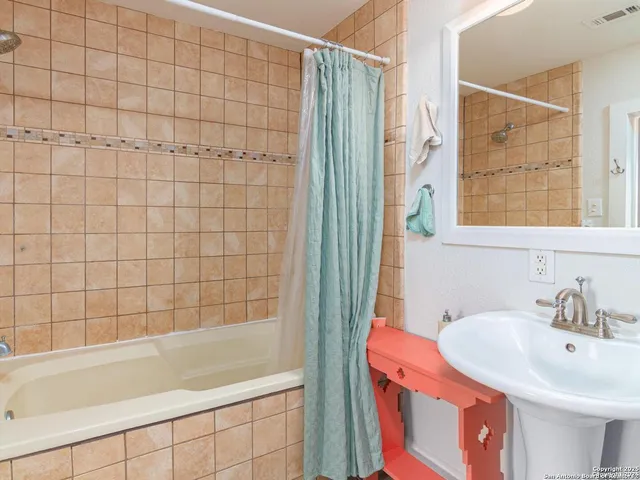 a bathroom with a bathtub and a sink