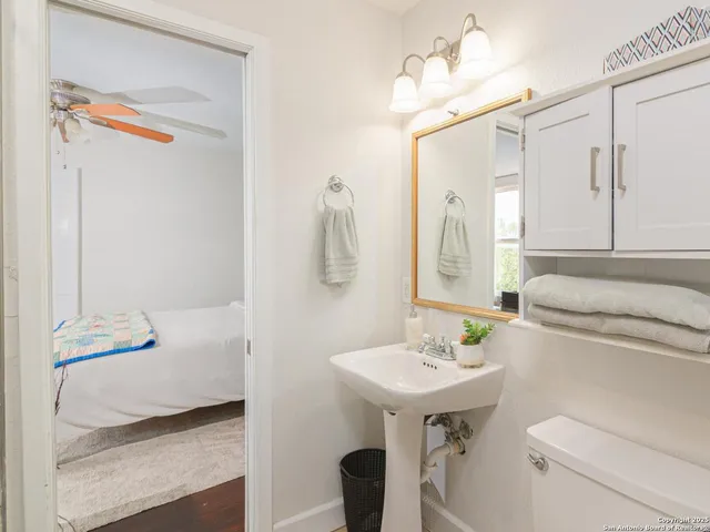 a bathroom with a sink vanity granite and a mirror
