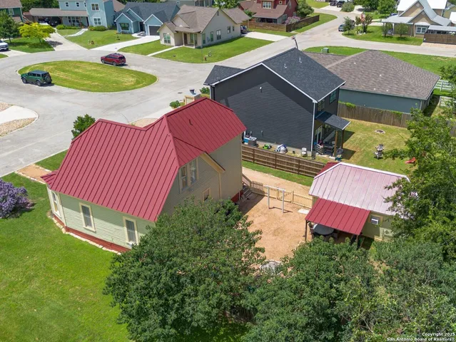 an aerial view of a house with garden space and street view
