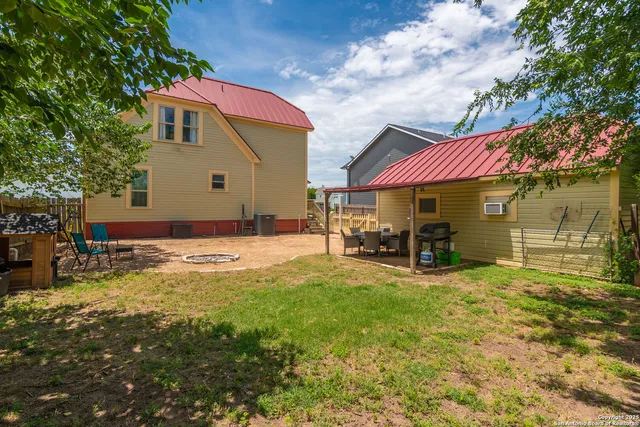 a view of a house with a yard and sitting area