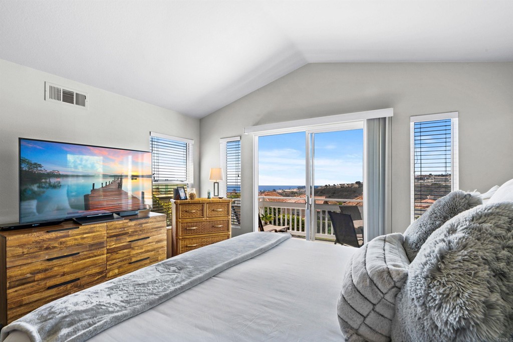 7 Monaco Dana Point, CA 92629 - Photo 16 of 32 a bedroom with a large bed and a large window