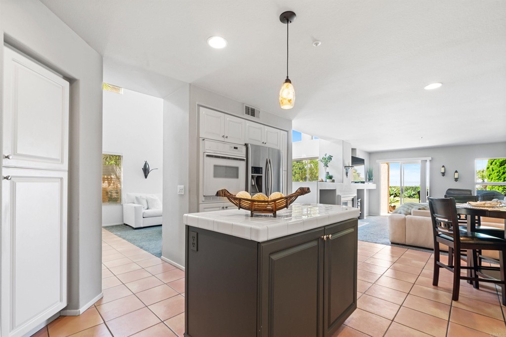 7 Monaco Dana Point, CA 92629 - Photo 9 of 32 a kitchen with a counter space dining table and chairs
