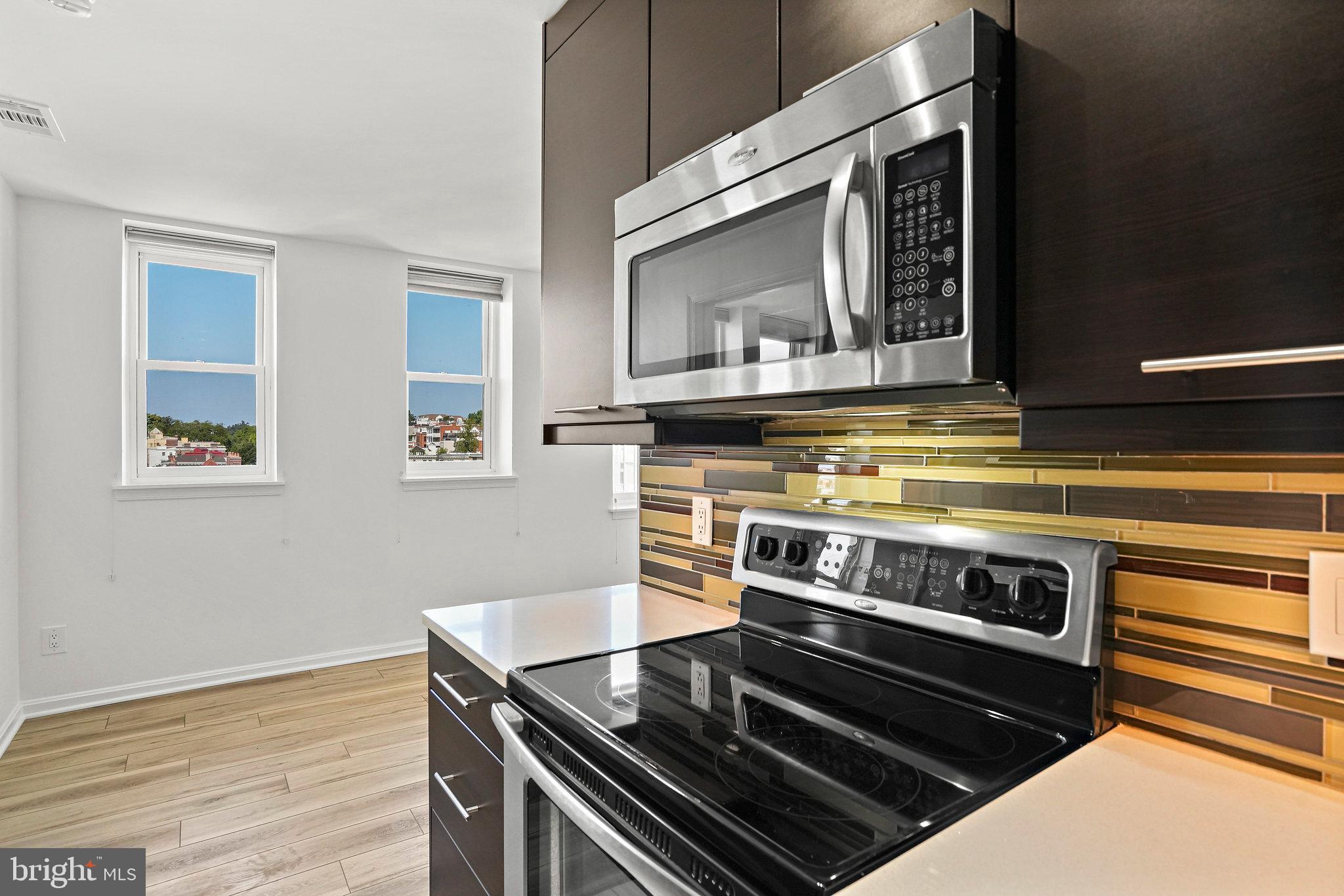 1920 S Street Northwest, Unit 804 Washington, DC 20009 - Photo 13 of 25 a kitchen with stove and cabinets