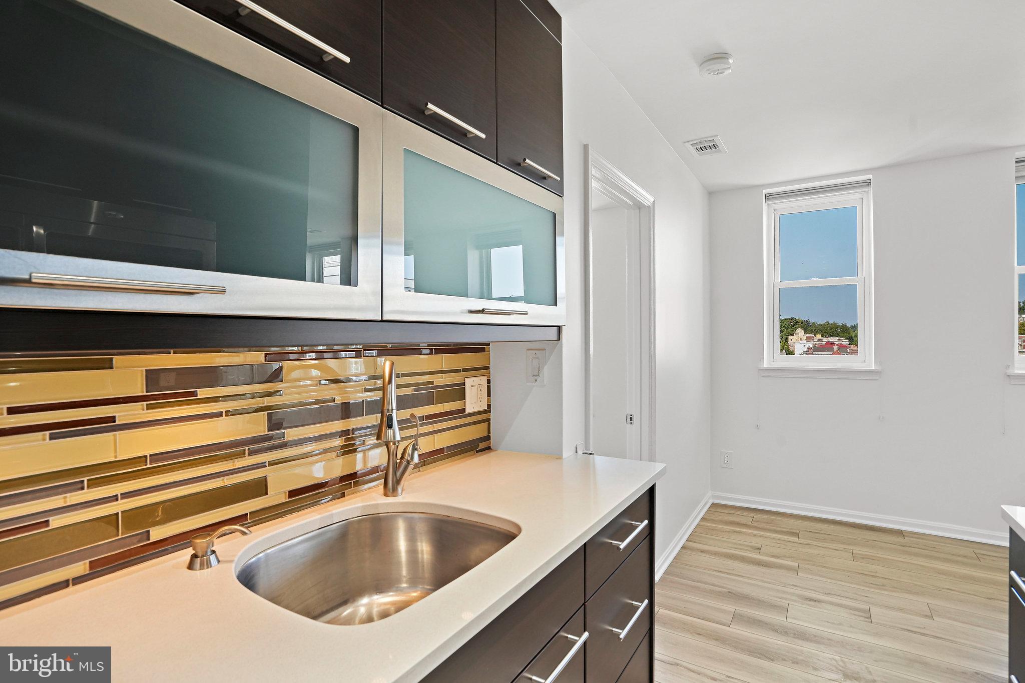 1920 S Street Northwest, Unit 804 Washington, DC 20009 - Photo 14 of 25 a kitchen with a sink and cabinets