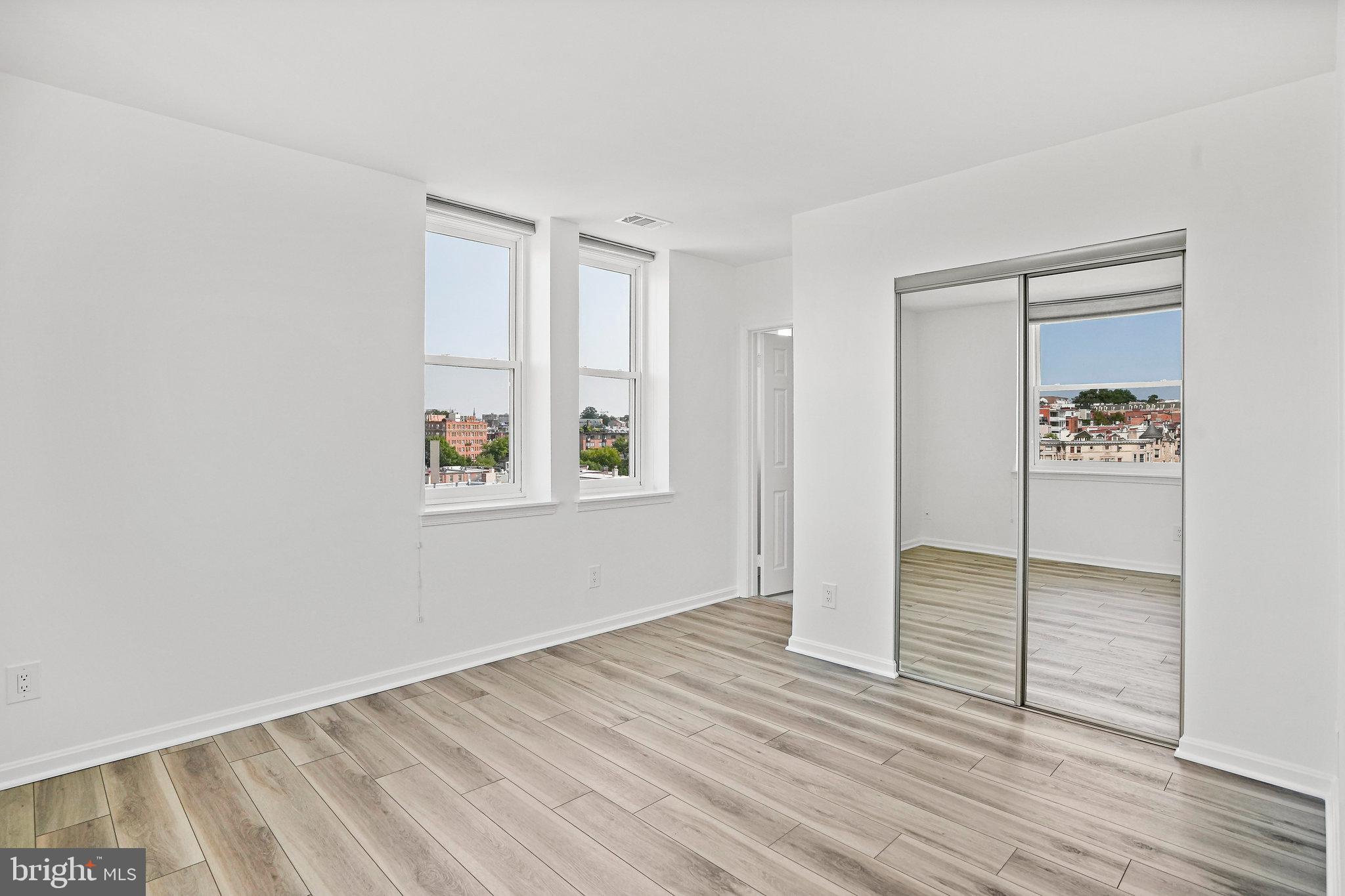 1920 S Street Northwest, Unit 804 Washington, DC 20009 - Photo 18 of 25 an empty room with wooden floor and window