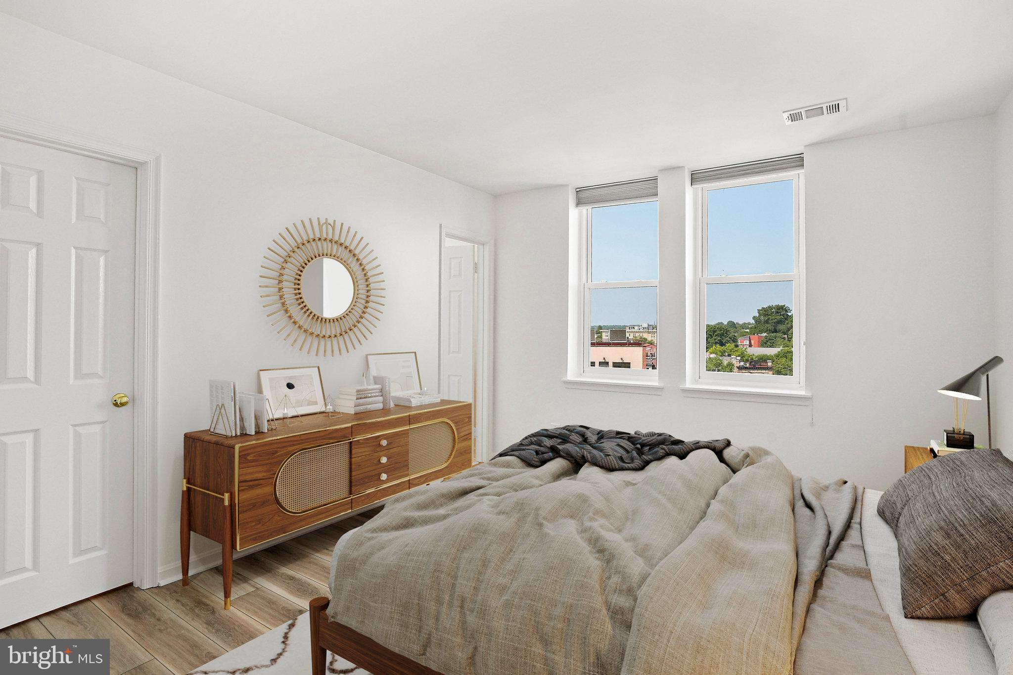 1920 S Street Northwest, Unit 804 Washington, DC 20009 - Photo 20 of 25 a bedroom with a bed and a chandelier