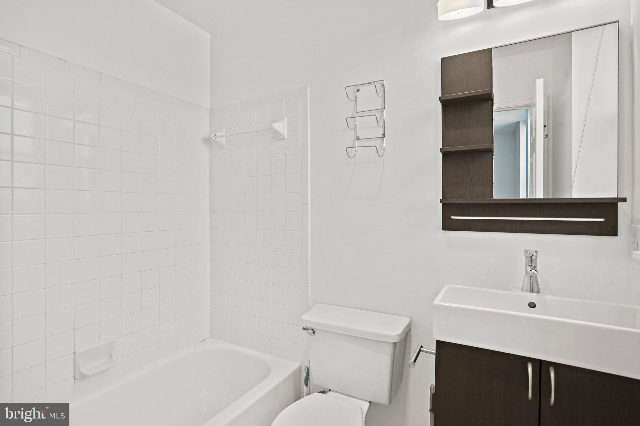 1920 S Street Northwest, Unit 804 Washington, DC 20009 - Photo 21 of 25 a bathroom with a sink a toilet and shower