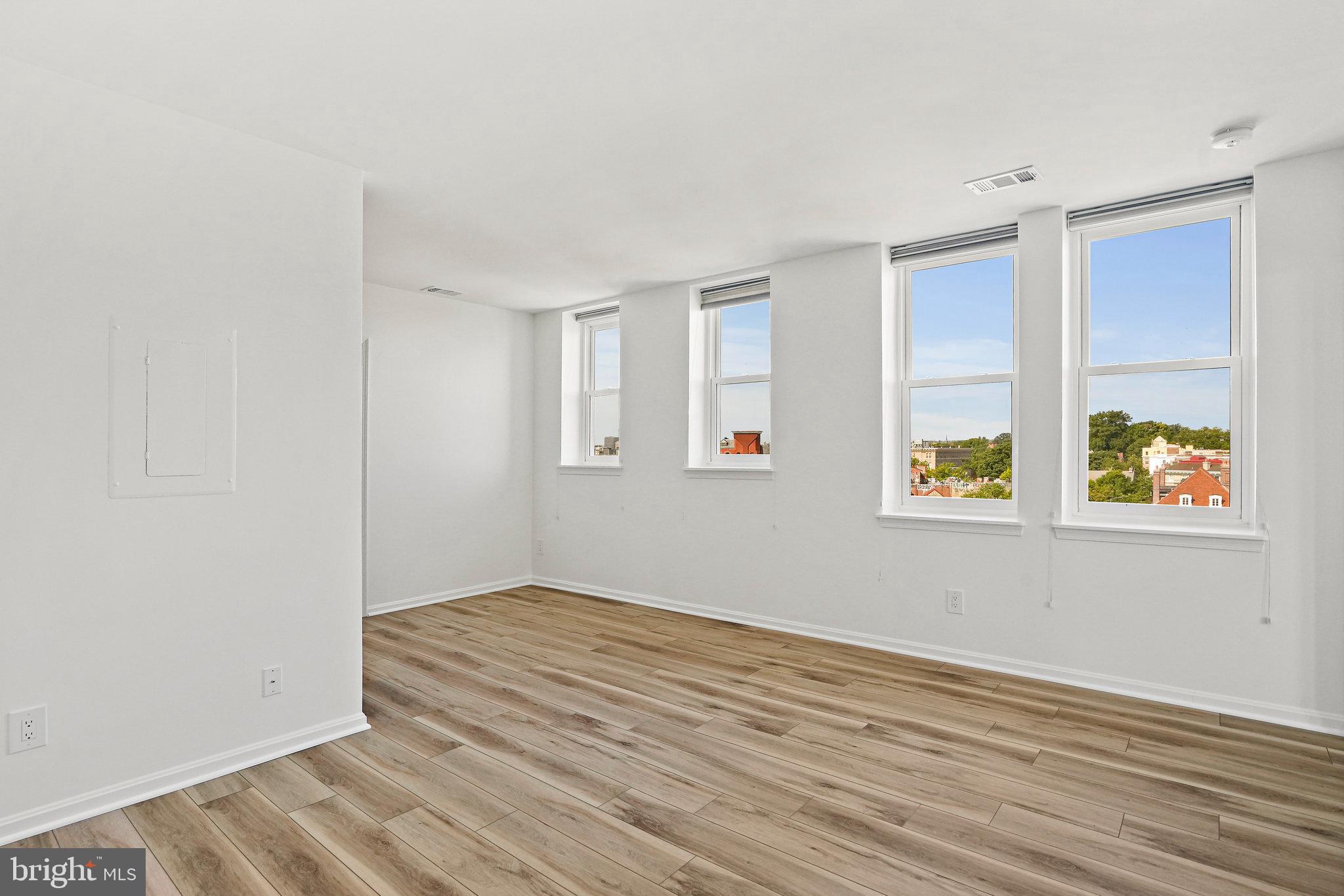 1920 S Street Northwest, Unit 804 Washington, DC 20009 - Photo 6 of 25 wooden floor in an empty room with a window