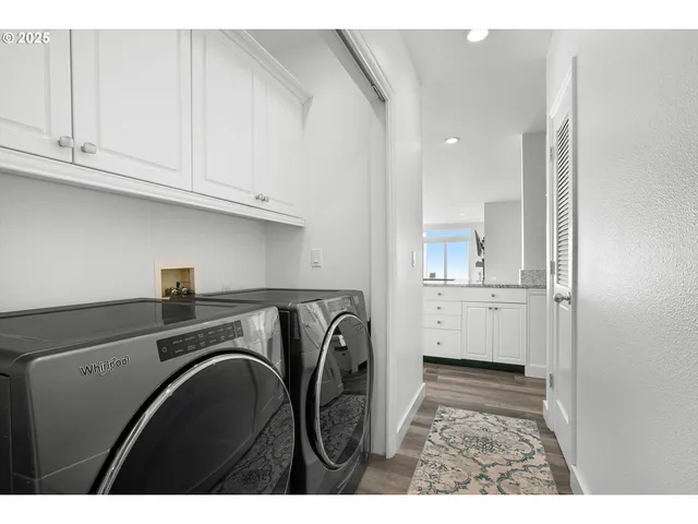 a utility room with sink dryer and washer