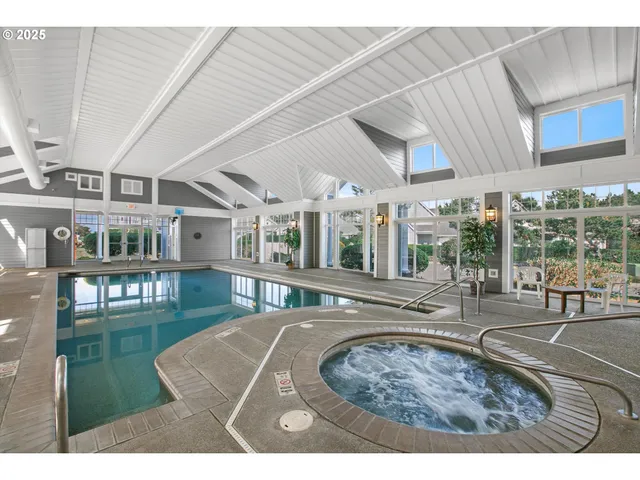 a swimming pool with outdoor seating and yard