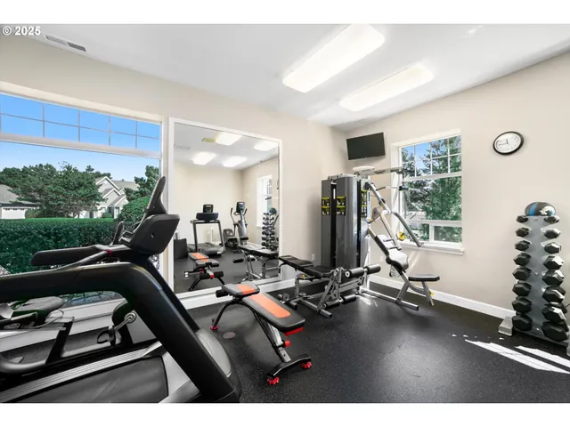a room with gym equipment and a large window