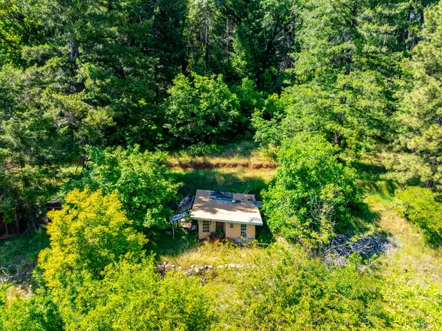 a backyard of a house with a yard and outdoor seating