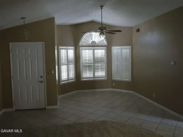 a view of big room with windows and chandelier