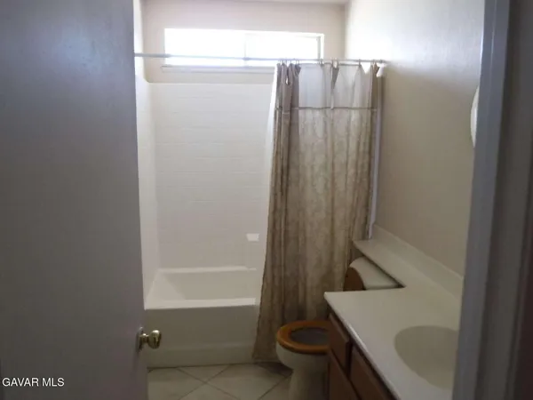 a bathroom with a shower and a sink