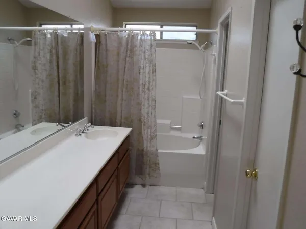 a bathroom with a double vanity sink and mirror