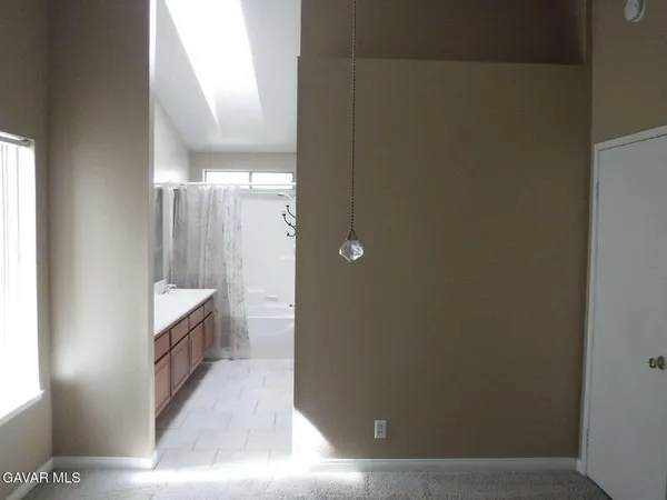 a bathroom with a double vanity and a mirror