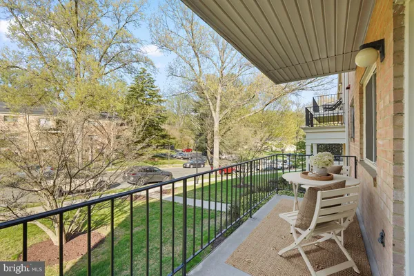 a porch with a table and chairs