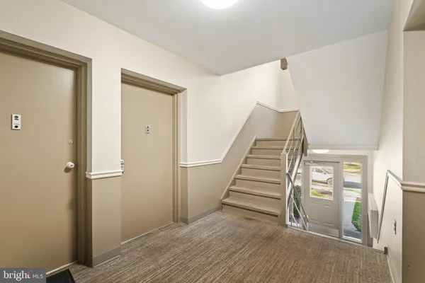 a view of staircase with railing and white walls