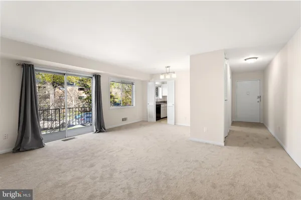 an empty room with windows and closet