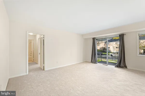an empty room with floor to ceiling windows