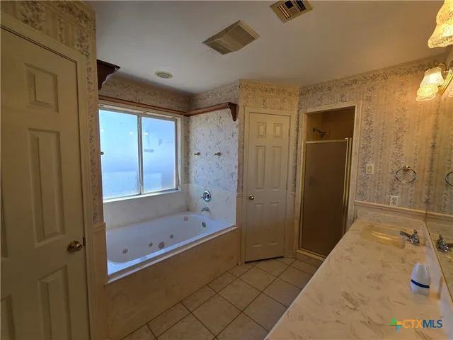 a bathroom with a bathtub and a shower