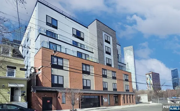 a lobby with furniture and a glass door
