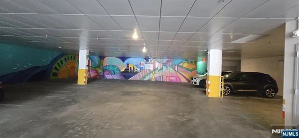 a view of a hallway with furniture and a large window