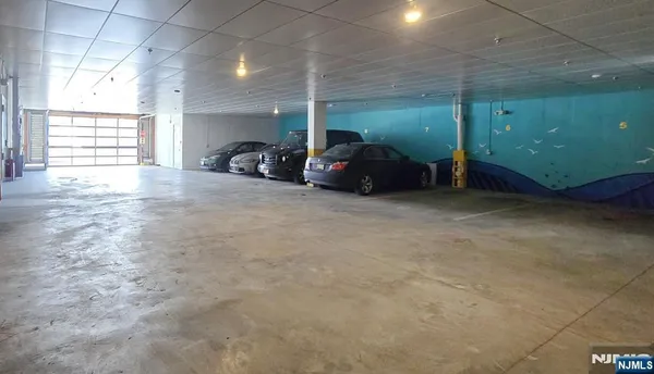 a dining hall with stainless steel appliances kitchen island a stove a table and chairs