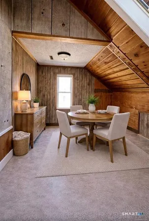 a dining room with a wooden table and chairs