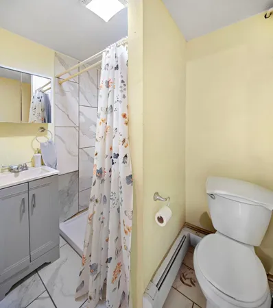 a bathroom with a sink a toilet and a mirror